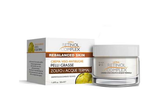 Crema viso in vasetto bianco con etichetta Retinol Complex e scatola grigia
