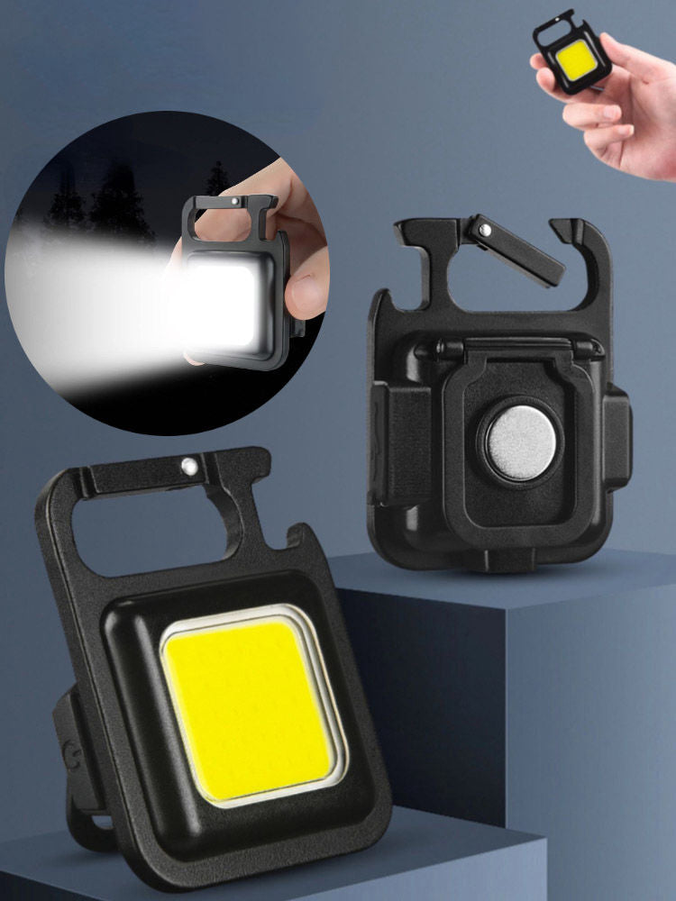 Portachiavi mini torcia nera con luce gialla quadrata accesa e gancio metallico