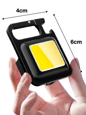 Portachiavi mini torcia nera con luce gialla, dimensioni 4cm e 6cm indicate