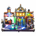 Stazione natalizia in miniatura con luci LED, movimento e personaggi su base in mattoni