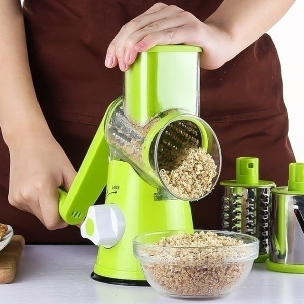 Affettatrice grattugia verde con tamburo metallico e manico, con scaglie in ciotola