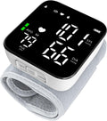 Misuratore di pressione da polso con display LED acceso e cinturino grigio chiaro