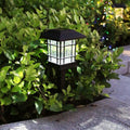 Lampada LED da giardino con corpo nero e lanterna trasparente, luce a griglia