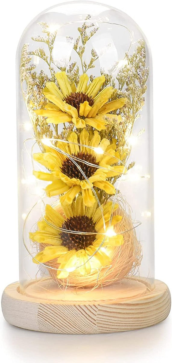 Cupola di vetro con girasoli artificiali gialli e base in legno con luci LED