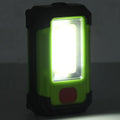 Faretto solare LED portatile con luce accesa in cornice rettangolare.