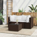 Set mobili da giardino in polyrattan marrone con cuscini bianchi e tavolino