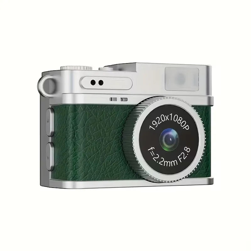 Mini fotocamera portachiavi con corpo verde goffrato, lente rotonda e scocca argento.