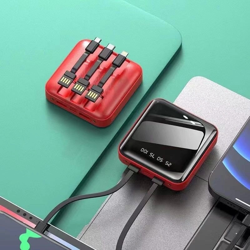 Power bank compatto rosso con cavi integrati e display LED scuro
