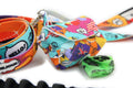 Dispenser per sacchetti per deiezioni canine in tessuto multicolore con clip e sacchetto verde