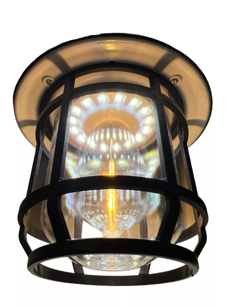Lampada solare LED nera illuminata, corpo cilindrico con griglia e lente
