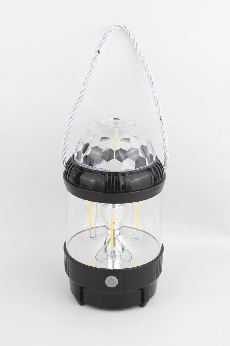 Proiettore LED portatile con cupola trasparente sfaccettata e maniglia in corda, base nera