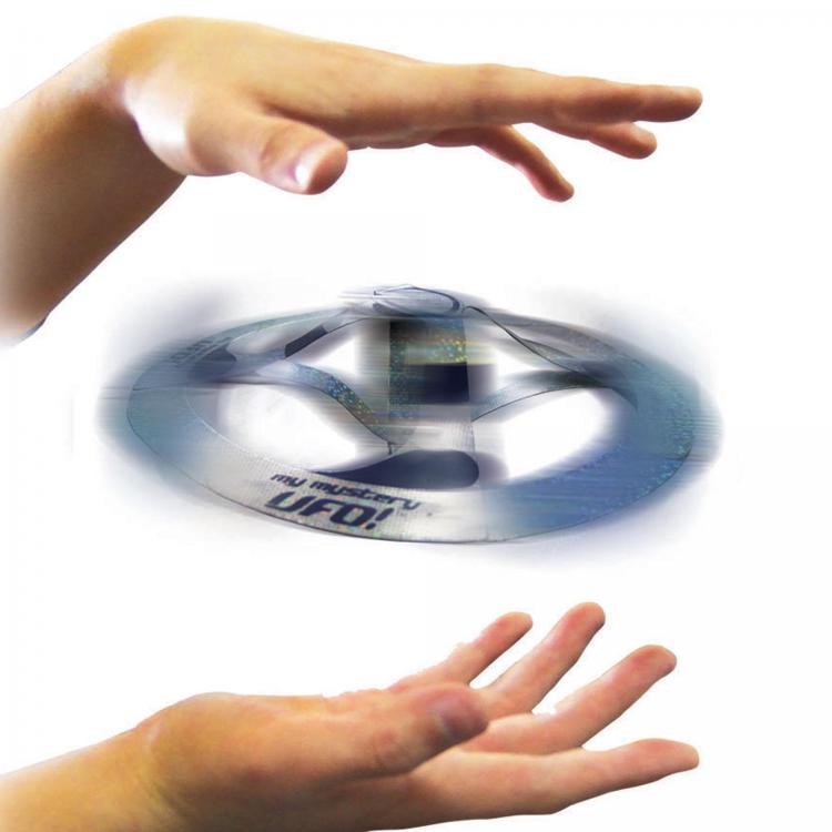 Giocattolo UFO fluttuante: disco argento-blu con glitter, mani sopra il disco