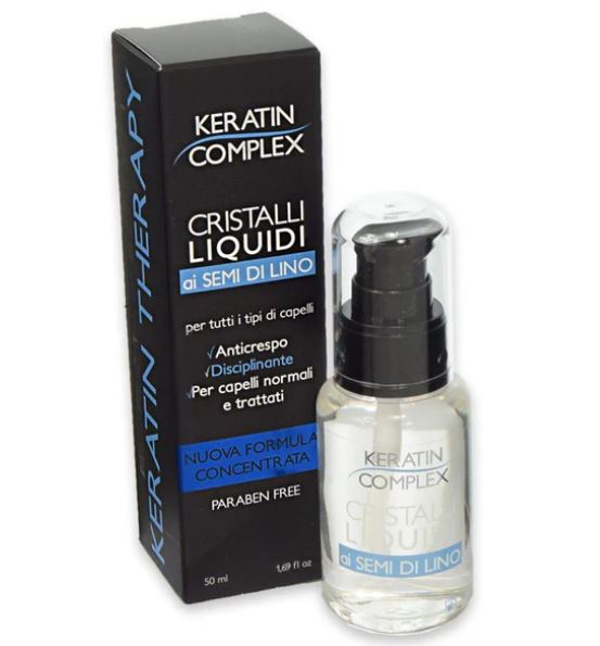 Trattamento liquido per capelli in flacone trasparente con pompetta e scatola nera con etichetta blu