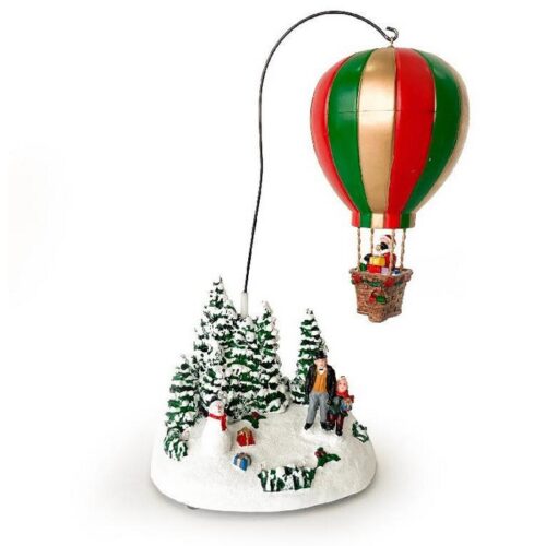 Decorazione natalizia con mongolfiera multicolore e scena innevata su base