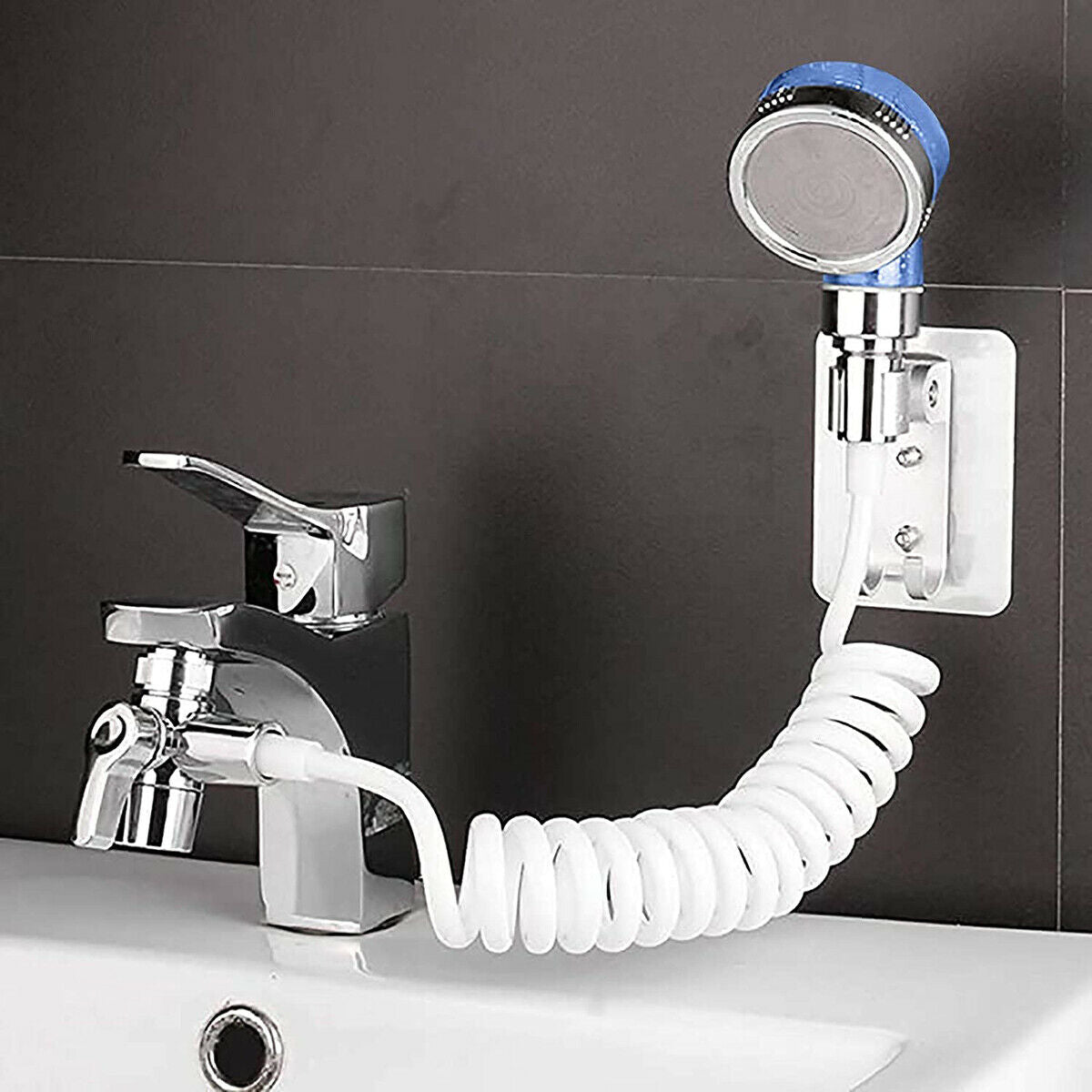 Doccetta portatile con soffione blu e tubo flessibile bianco collegato al rubinetto