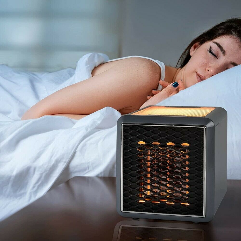 Stufa elettrica portatile grigia con griglia frontale illuminata arancione e cornice